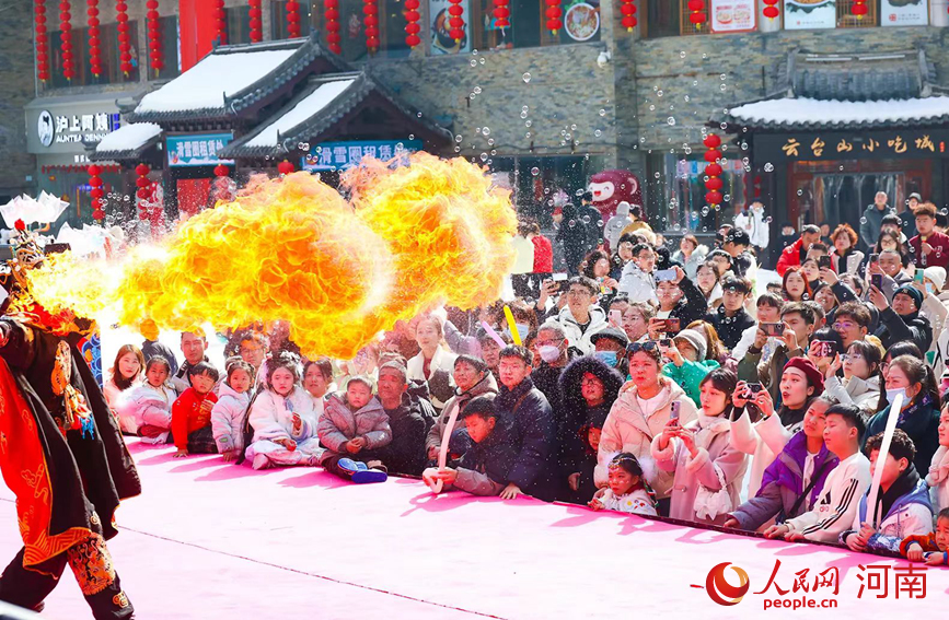 精彩的“喷火”表演引来游客喝彩。人民网记者 王佩摄