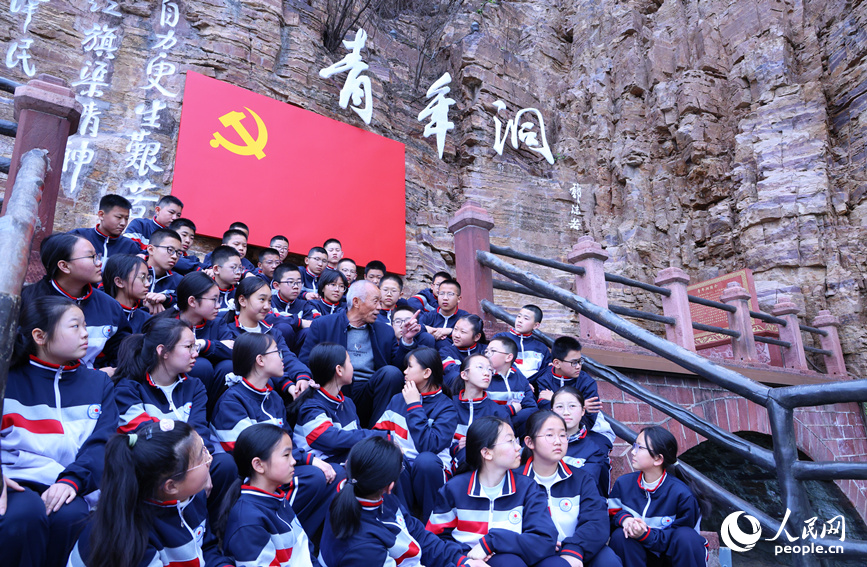 红旗渠劳模张买江与同学们讲述修渠经历。人民网 霍亚平摄